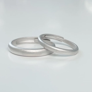 Detailed macro shot of S925 sterling silver matte minimalist adjustable couple rings