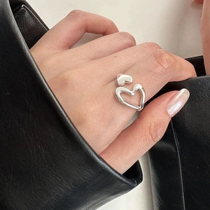 Macro detail of S925 sterling silver ring showing hollow and solid heart-shaped design