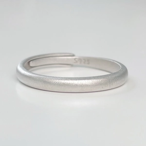 Close-up of S925 sterling silver stamp on a minimalist matte finish adjustable ring