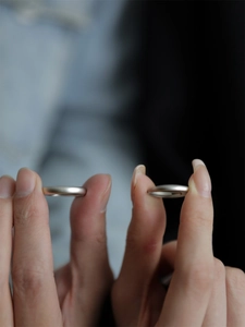 Detail view of matte silver minimalist rings with a thick rounded band design