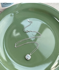Detailed macro view of S925 silver necklace featuring a square blue halo stone pendant