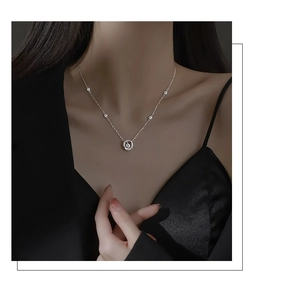 Close-up of S925 sterling silver Mobius necklace with a shimmering central stone