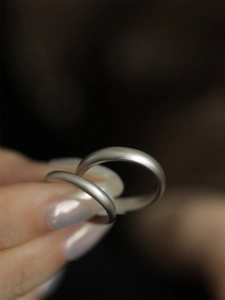 Detail view of simple matte S925 sterling silver couple rings with elegant frosted finish