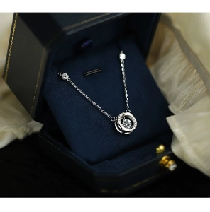 Detail of S925 silver Mobius necklace with a sparkling center stone in a gift box