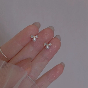 Elegant S925 silver bow stud earrings with white pearls and sparkling crystals