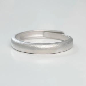 Macro detail of silver frosted couple ring with adjustable open band and matte finish