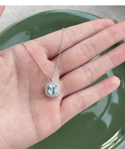 Detailed macro view of S925 silver necklace with square light blue zircon halo pendant