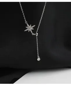 Macro shot of S925 sterling silver starburst pendant necklace with sparkling zirconia
