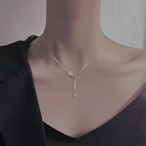 S925 sterling silver star pendant necklace with long zircon drop shown on model neck