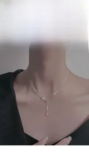 Close-up of S925 sterling silver starburst necklace with zircon pendant on a model