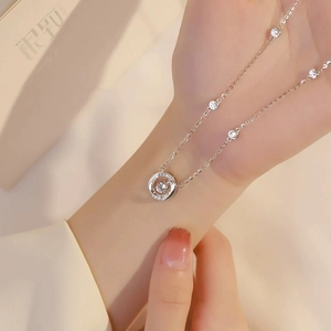 Detailed macro view of S925 silver Mobius necklace with sparkling dancing diamond pendant