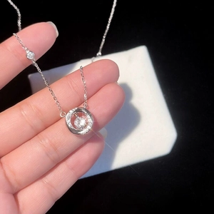 S925 sterling silver Mobius necklace with sparkling center stone held in hand