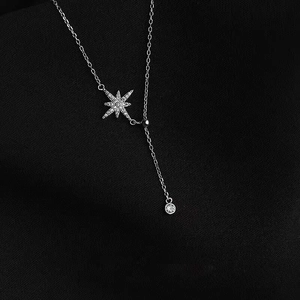 Detailed view of S925 sterling silver star pendant with tiny crystals on a Y-shaped chain
