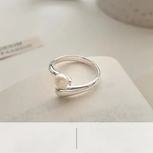Detail of a minimalist S925 sterling silver ring with a lustrous round white pearl
