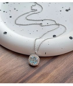 Detail of S925 silver necklace featuring a square halo light blue zircon pendant