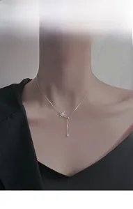 Detail of S925 silver necklace featuring a sparkling star pendant on a model's neck