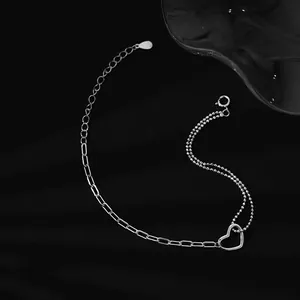 Macro shot of S925 sterling silver double-layer bracelet with hollow heart charm