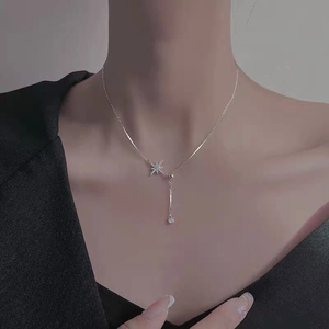 Elegant S925 sterling silver star necklace on model featuring a Y-shaped chain design
