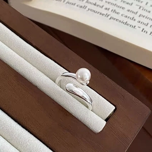 Detailed close-up of a S925 silver cross ring featuring a lustrous white pearl accent