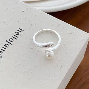 Macro shot of S925 sterling silver ring with a lustrous white pearl and adjustable open band