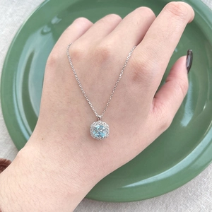 Elegant S925 sterling silver necklace featuring a square sea blue zircon pendant on model