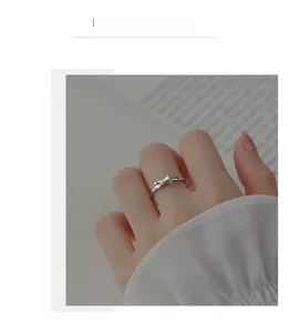 Detail shot of elegant S925 sterling silver bow ring worn on a finger for a minimalist look