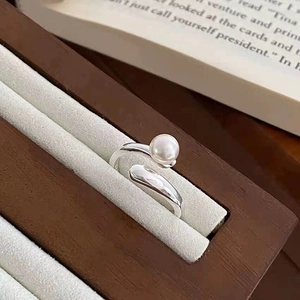 Detailed view of an S925 silver pearl ring displayed in a luxury grey velvet jewelry box