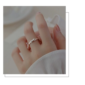 Detailed view of an elegant S925 sterling silver bow ring worn on a finger