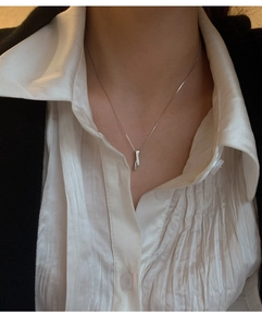 Detail of S925 silver necklace with double-row zircon vertical bar pendant on model