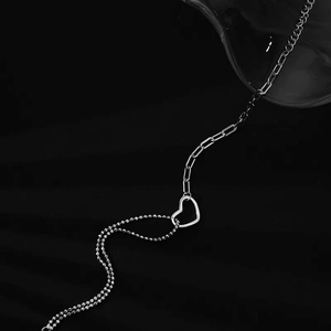 Minimalist S925 silver hollow heart bracelet featuring an asymmetric double-chain design