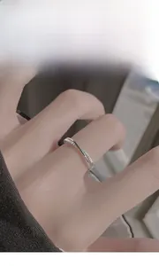 Detail of S925 silver criss-cross ring with shimmering cubic zirconia on model finger