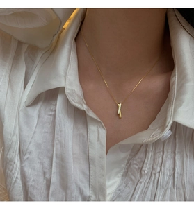 Close-up of interlocking geometric gold S925 necklace with pave-set zircon detail on model