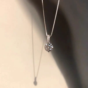 Close-up of S925 sterling silver necklace featuring a round brilliant solitaire pendant