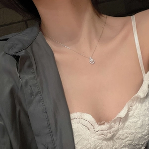 Detailed view of S925 sterling silver moon and star necklace with zircon on neck