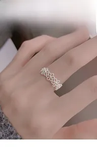 Detailed view of an S925 sterling silver open ring with hollow daisy flower patterns