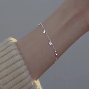 Detailed view of a slender S925 sterling silver heart bracelet with sparkling zircon