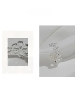Detail view of the S925 sterling silver ring showing the hollow flower pattern and hallmark