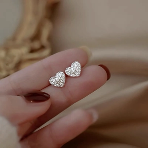 Macro shot of S925 sterling silver heart studs with unique textured foil finish