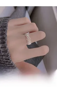 Detail of S925 sterling silver daisy ring on hand showing intricate floral pattern