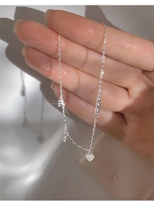 Detailed macro view of S925 silver heart bracelet featuring sparkling cubic zirconia charms