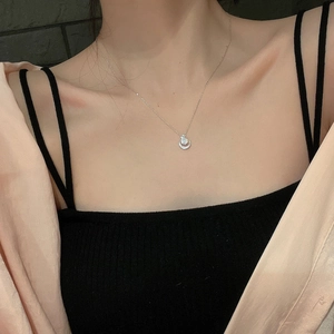 Close-up of S925 sterling silver crescent moon necklace with zircon on female collarbone