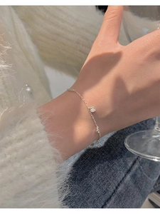 Close-up of S925 sterling silver heart bracelet with crystals on a woman's wrist
