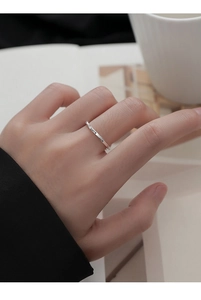 Detailed close-up of S925 sterling silver Luck engraved ring on a model's finger