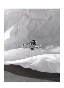 Macro shot of S925 silver thorn rose ring with vintage blackened petals and vine texture