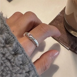 Close-up of S925 sterling silver ring with pink heart stone on a model finger