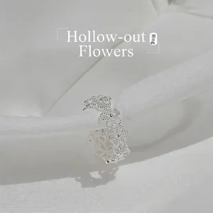 Minimalist S925 sterling silver open ring with hollow flower design on white silk