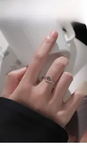 Detailed view of S925 sterling silver thorn rose ring worn on a finger for style