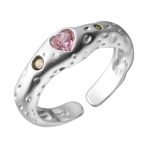 Detail shot of irregular lava texture ring with heart pink zircon and side accent stones