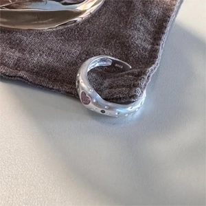 Detail view of S925 sterling silver hammered texture ring with pink heart stone inlay