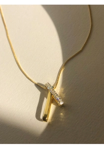 Macro shot of interlocking S925 silver pendants with gold finish and zircon pave